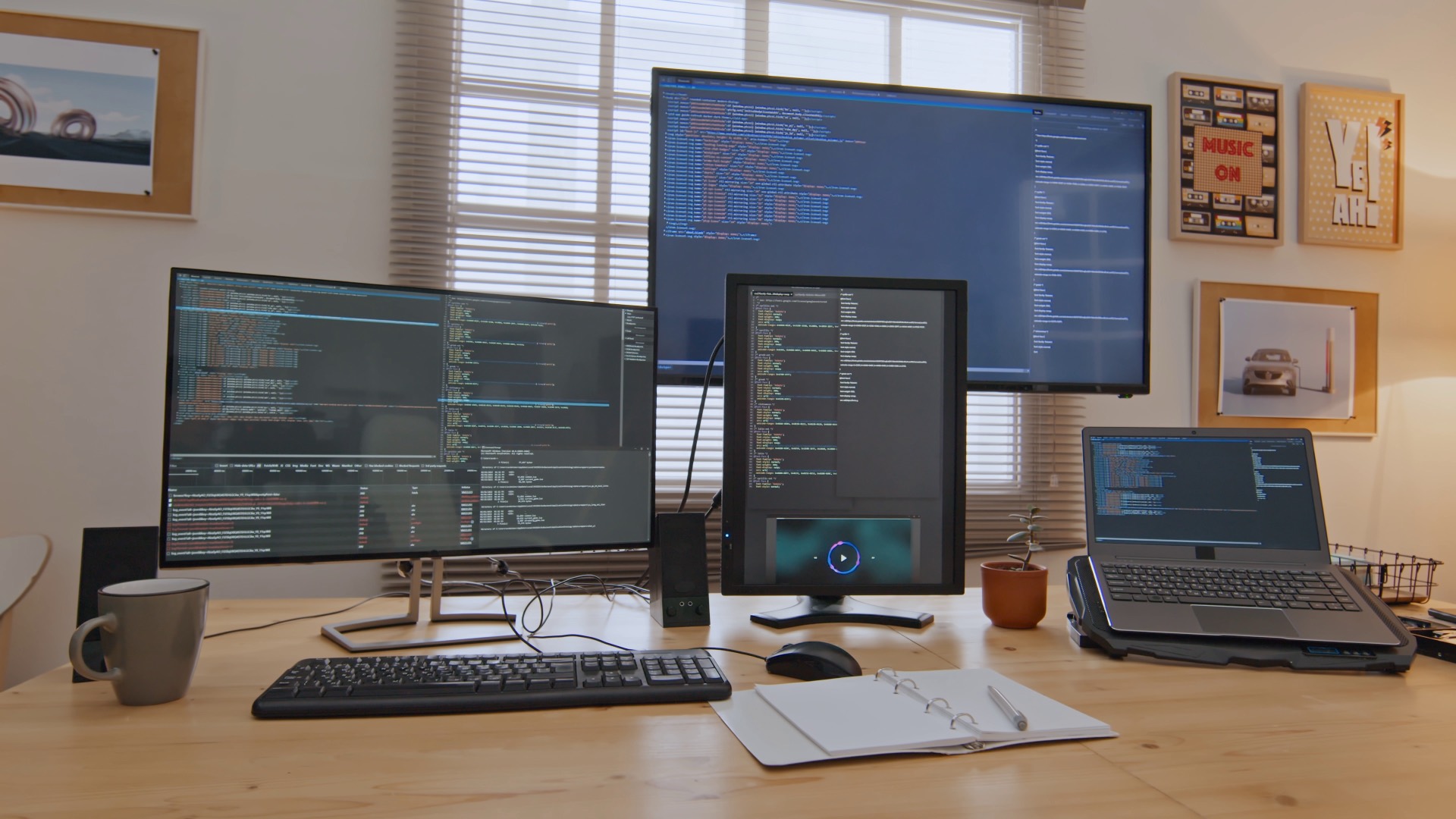 Software engineer's desk with code on multiple monitors