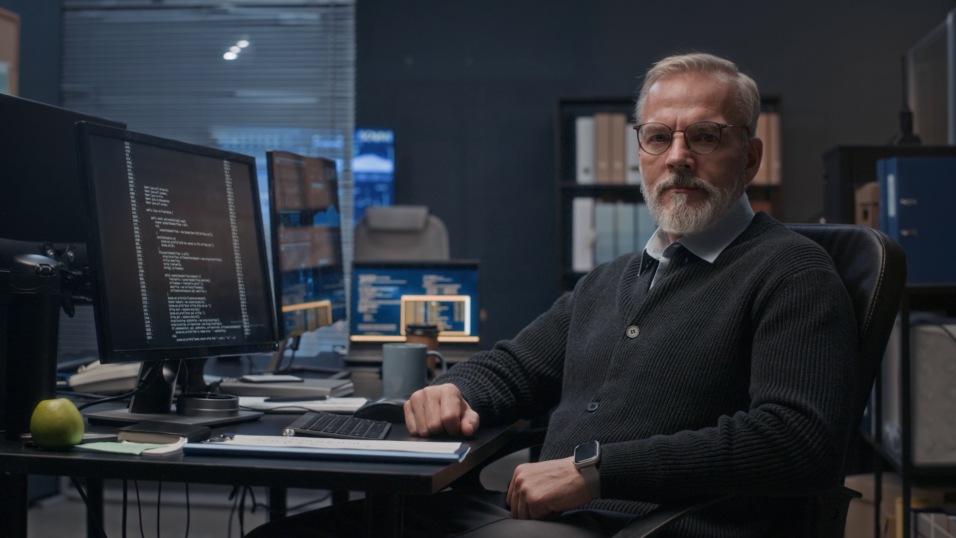 Senior engineer working with code on screen